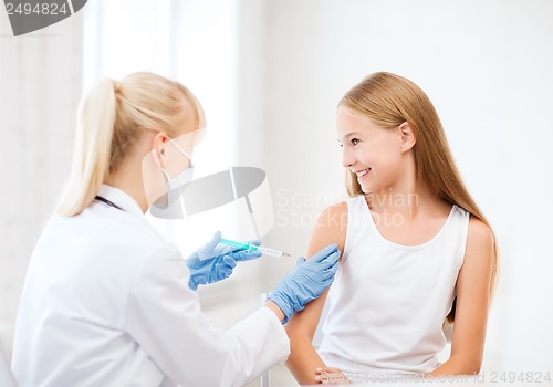 Image of doctor doing vaccine to child in hospital