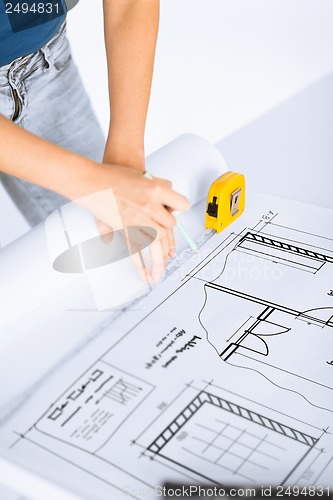 Image of architect drawing on blueprint