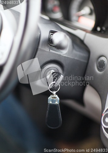 Image of car key in ignition start lock