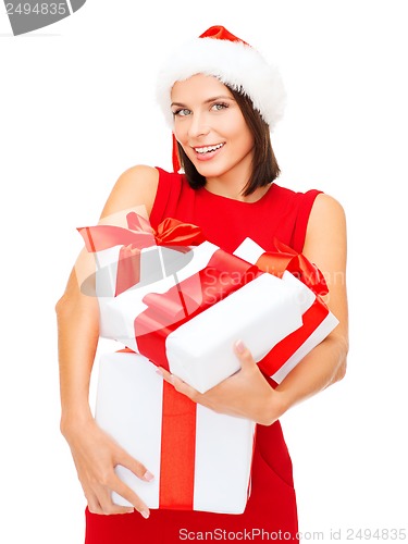 Image of woman in santa helper hat with many gift boxes