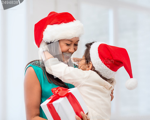 Image of happy mother and child girl with gift box