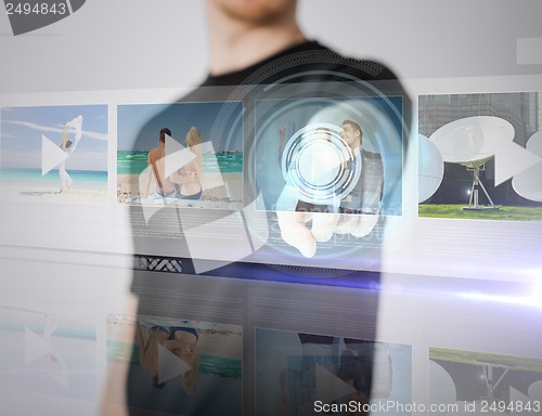 Image of man pressing button on virtual screen