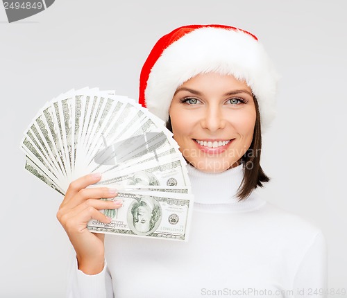 Image of woman in santa helper hat with us dollar money