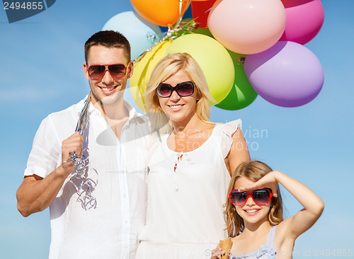 Image of family with colorful balloons