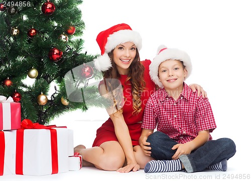 Image of happy mother and child boy with gift boxes