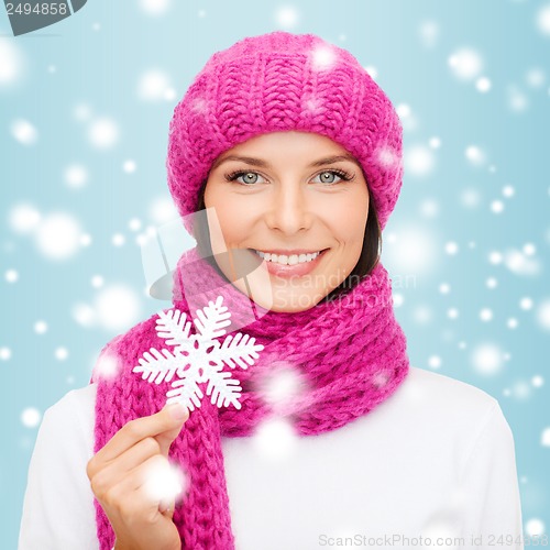 Image of woman in hat and muffler with big snowflake