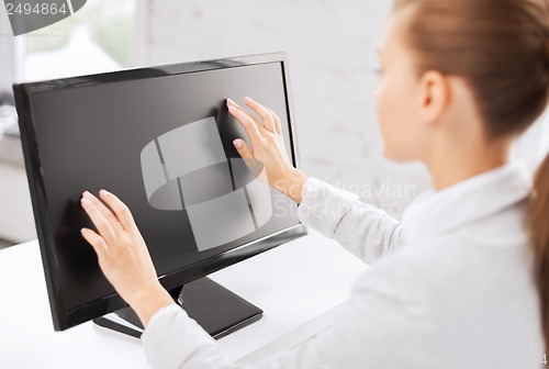 Image of smiling businesswoman with touchscreen in office