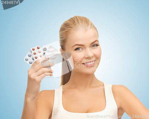 Image of young woman with pills