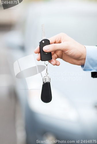 Image of man with car key outside