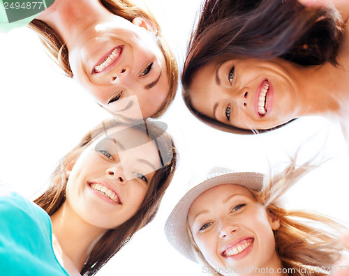 Image of faces of girls looking down and smiling