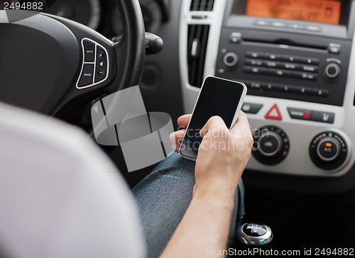 Image of man using phone while driving the car