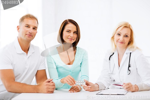 Image of doctor giving pills to patients