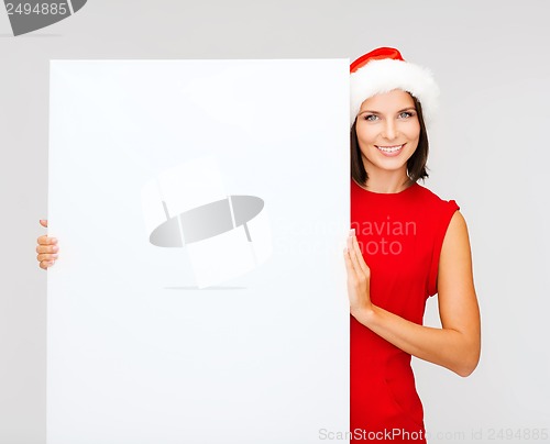 Image of woman in santa helper hat with blank white board