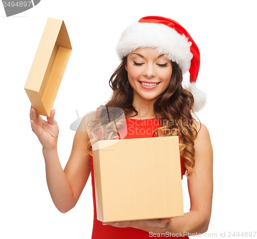 Image of smiling woman in santa helper hat with gift box
