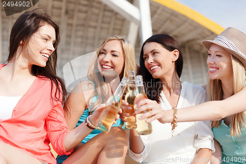 Image of girls with drinks on the beach