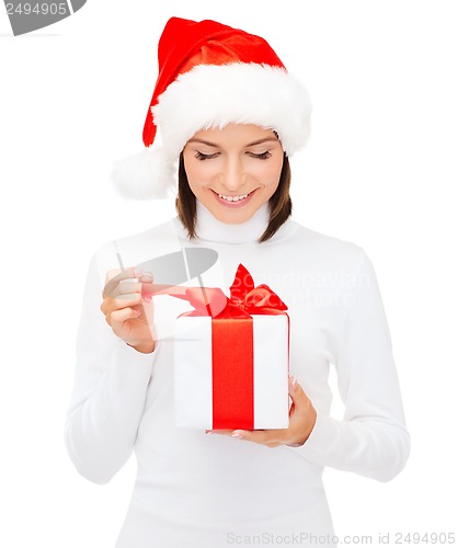 Image of smiling woman in santa helper hat with gift box