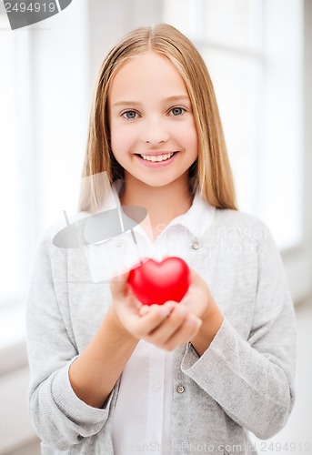 Image of beautiful teenage girl showing red heart