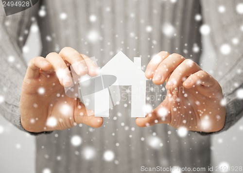 Image of man holding paper house