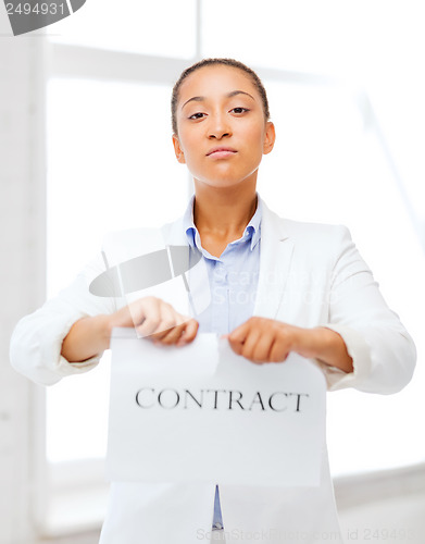 Image of african businesswoman tearing contract