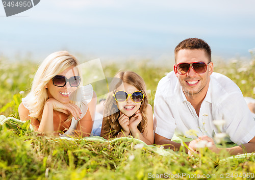 Image of happy family with blue sky and green grass