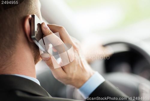 Image of man using phone while driving the car