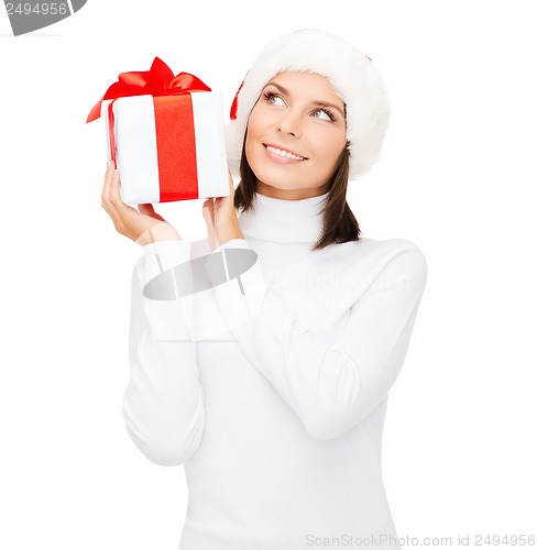 Image of smiling woman in santa helper hat with gift box