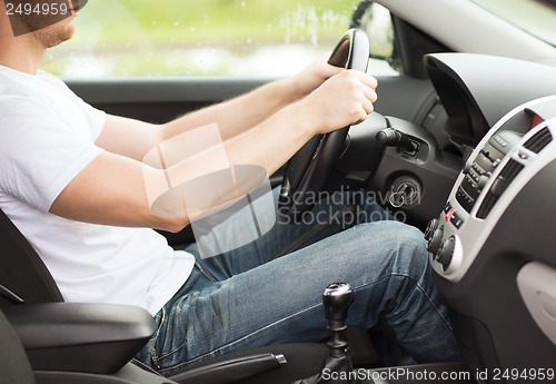 Image of man driving the car with manual gearbox