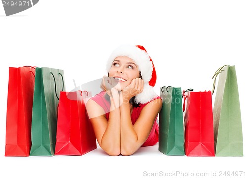 Image of woman in red shirt with shopping bags