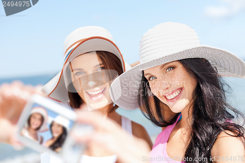 Image of girls taking self portrait on the beach