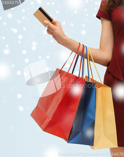 Image of woman with shopping bags and credit card