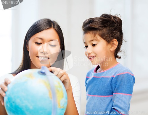 Image of mother and daughter with globe