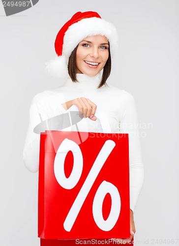 Image of woman in santa helper hat with shopping bags