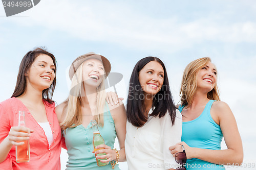 Image of girls with drinks on the beach