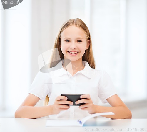 Image of girl with smartphone at school