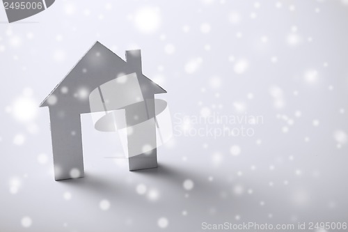 Image of white paper house over white background