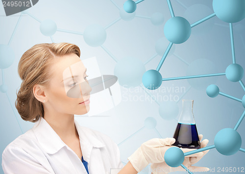 Image of lab worker holding up test tube