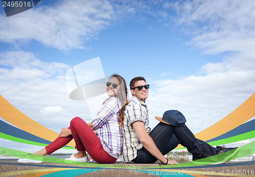 Image of teenagers sitting back to back