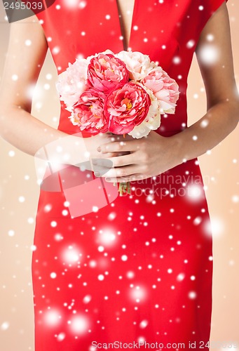 Image of woman hands with bouquet of flowers