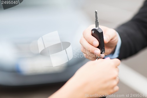 Image of customer and salesman with car key