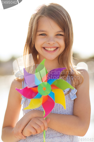 Image of happy girl with colorful pinwheel toy