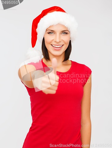 Image of woman in santa helper hat showing thumbs up