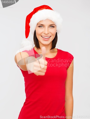 Image of woman in santa helper hat showing thumbs up