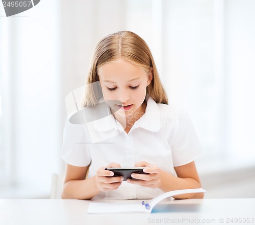 Image of girl with smartphone at school