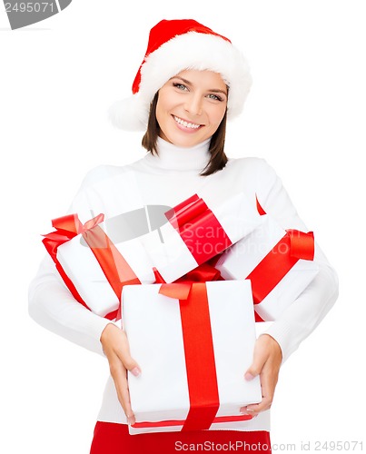 Image of woman in santa helper hat with many gift boxes