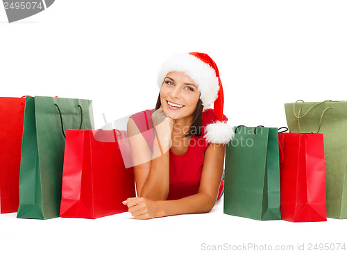Image of woman in red shirt with shopping bags