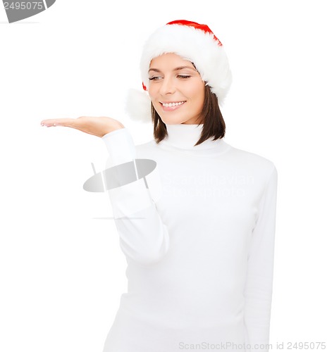 Image of woman in santa helper hat with something on palm