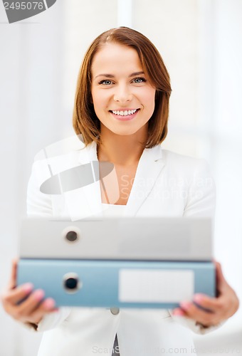 Image of businesswoman with folders in office