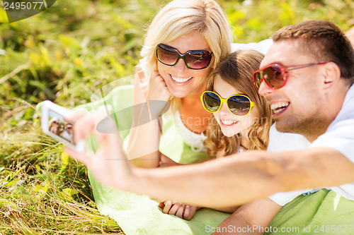 Image of happy family with camera taking picture