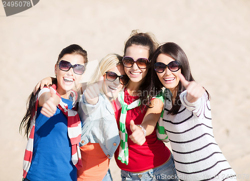 Image of teenage girls or young women showing thumbs up