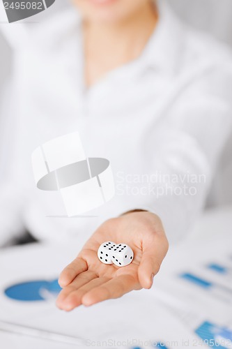 Image of man hands with gambling dices signing contract